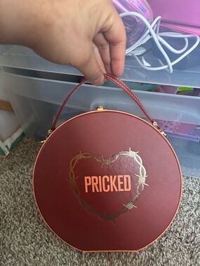 Round Maroon 'PRICKED' Handbag with Gold Heart Detail
